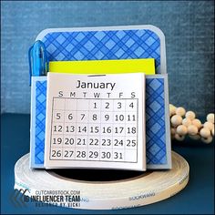 a desk calendar sitting on top of a roll of tape