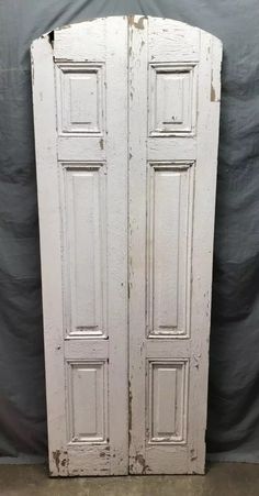 an old white double door is shown against a gray background