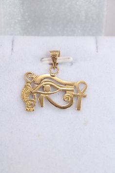 "Egyptian carving Pendant Handmade Eye Of Horus + Ankh Cross 18K Gold 2.2 Gr Weight Approximate : 2.2 Gr Height : 0.7\" = 19 mm Width : 0.9\" = 24 mm ✔ IT IS Tested & SIGNED WITH THE EGYPTIAN Gold Government HALLMARK FOR 18K GOLD to Ensure Authenticity. ✔ Lovely gift idea ABSOLUTELY GORGEOUS, LOOKS FABULOUS ON. ✔ 100% Egyptian handmade. ✔ Condition: A brand-new, exactly as on the photos. ★ GIFTS ✔ All items are packaged in a paper jewelry gift box, ready for gifting. ✔ If you are sending a gift