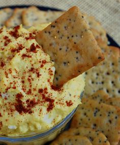 crackers and dip in a bowl on a plate