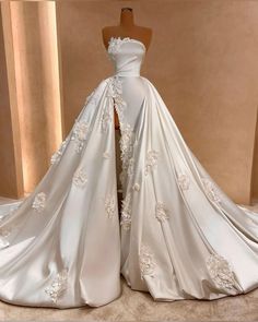 a white wedding dress with flowers on it