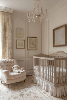 a baby's room with a crib, chair and chandelier