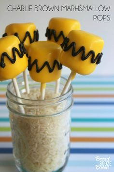 some yellow marshmallow pops are in a jar