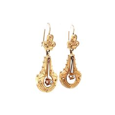 Victorian Style Diamond Earrings in Yellow Gold. These Victorian style drop yellow gold earrings are completed in 14 karat gold. The earrings feature wonderful hand engraved patterns and open work with a diamond hanging in the center. They are set with two (2) .04 carat diamonds and measure about 1.5 inches in length. Formal Engraved Yellow Gold Earrings, Antique Yellow Gold Drop Earrings, Ornate Yellow Gold Oval Earrings, Victorian Yellow Gold Drop Earrings, Yellow Gold Engraved Drop Earrings, Victorian Style Engraved Yellow Gold Earrings, Victorian Engraved Yellow Gold Earrings, Formal Engraved Drop Earrings, Engraved Yellow Gold Drop Earrings