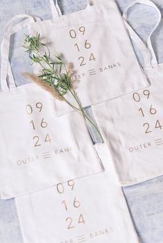 three bags with numbers and plants on them