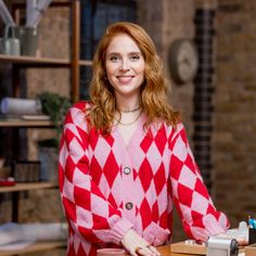 a woman standing in front of a desk