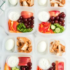 four plastic containers filled with different types of food