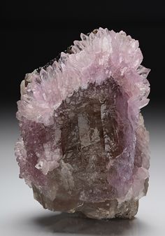 Classic pink crystal Rose Quartz forms an arch-like configuration and as an almost complete girdle around the specimen of lightly coloured Smoky Quartz, with inclusions of black Schorl. From the Taquaral area Brazil. Rock And Minerals, Rock Minerals, Pretty Rocks, Cool Rocks, Rocks Crystals, Beautiful Rocks, Gems And Crystals, Gems Crystals, Crystal Rose