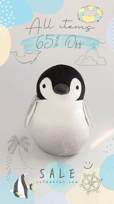 a penguin stuffed animal sitting on top of a white surface with blue and yellow clouds in the background