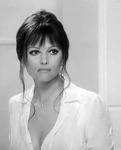 a woman with very large breast wearing a white shirt and posing in front of a mirror