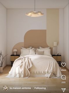 an image of a bedroom setting with white and beige colors on the walls, bedding and pillows