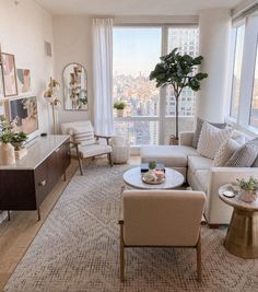 a living room filled with furniture next to a window and a large window sill