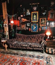 a zebra print couch sitting in front of a wall with pictures and lights on it