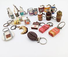 there are many different types of items on this white surface, including key chains and lighters