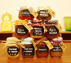 a stack of jars filled with jam sitting on top of a wooden table