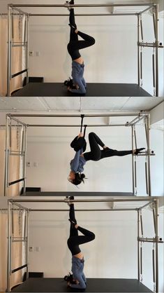 two women doing aerial acrobatic exercises in front of a white wall and black floor