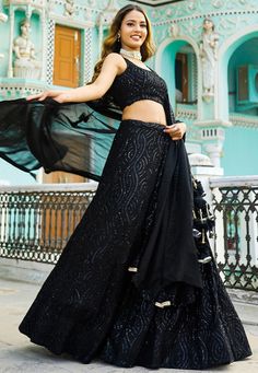 Readymade Faux Georgette Lehenga in Black. This attire with Shantoon and Cotton Lining is Enhanced with Fancy Tassels, Resham and Sequins Work. Available with a Sleeveless Faux Georgette Black Choli Crafted in Round Neck and a Faux Georgette Dupatta in Black. The Choli and Lehenga Lengths are 14 and 42 inches respectively. Do Note: Accessories shown in the image are for presentation purposes only. (Slight variation in actual color vs. image is possible). We sell all kinds of Lehenga and Chaniya Evening Embroidered Georgette Lehenga, Black Embroidered Sharara For Evening, Black Lehenga For Eid Reception, Black Lehenga For Reception On Eid, Black Sharara For Evening Navratri Festival, Embellished Black Sharara For Eid, Black Lehenga For Reception And Eid, Embroidered Black Sharara For Evening, Black Embellished Traditional Party Wear