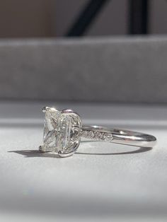 a diamond ring sitting on top of a table