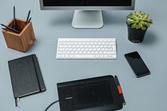 an office desk with computer, tablet and other items on it - stock photo - images