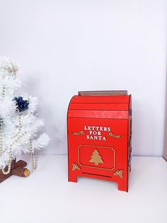 a red mailbox next to a white christmas tree