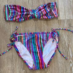 Striped Bandeau Bikini Set Brand: Victoria’s Secret Size: Small Color: Multi-Stripe Flattering Bandeau Top (Not Lined) String Bikini Bottom With Ties At Hips Excellent Condition!! Never Worn!! No Stains Or Signs Of Wear From A Smoke & Pet-Free Home Multicolor Strapless Stretch Swimwear, Multicolor Bandeau Tankini For Pool, Multicolor Bandeau Swimwear For Pool, Multicolor Bandeau Swimwear For Beach, Multicolor Bandeau Tankini For Beach Season, Multicolor Bandeau Swimwear For Beach Season, Multicolor Bandeau Swimwear For Spring, Beachy Multicolor Bandeau Swimwear, Beachwear Multicolor Bandeau Swimwear