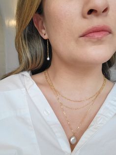 These Pearl and 14K Gold Filled chain earrings are delicate and minimal! The dainty gold paperclip chain attaches to the back of each stud and creates a gorgeous modern look. Prepare to get tons of compliments on these earrings! * 14K Gold Filled circle studs and chain * 2.25" length * 6mm slightly irregular Freshwater Pearls * Made with all hypoallergenic materials 🤍 *Please note for the health and safety of my customers, and to uphold the highest quality standards - these earrings are final s Delicate 14k Gold Filled Threader Earrings, Everyday Delicate Chain Gold-plated Earrings, Gold Plated Delicate Chain Earrings For Everyday, Everyday Gold-plated Earrings With Delicate Chain, Everyday Gold Plated Delicate Chain Earrings, Dainty Earrings With Delicate Chain, Dainty White Earrings With Delicate Chain, Dainty Gold Plated Earrings With Delicate Chain, Delicate Yellow Gold Earrings With Chain