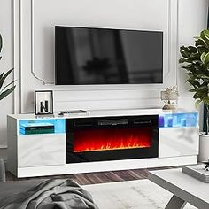 a living room with a large television and fire in the fireplace on it's side