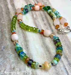 I was inspired by the ever colorful Red Eyed Tree Frog. This necklace features multiple high quality gemstones ~🔹3 AAA Ethiopian Opals🔹Chrysocolla🔹Fluorite🔹Orange Adventurine🔹Carnelian 🔹Black Spinel🔹Peridot🔹Chrome Diopside 🔹Blue Apatite🔹.925 Sterling Silver Clasp and bead toppers. 🔶All gemstones are high quality and completely natural. 20” Length Artisan Green Multi-stone Necklaces, Multicolor Spiritual Necklaces With Gemstone Accents, Spiritual Multicolor Necklace With Gemstone Accents, Artisan Green Multi-stone Necklace, Fusion Style Green Necklace With Natural Stones, Green Multi-stone Spiritual Necklace, Spiritual Green Multi-stone Necklace, Unique Multicolor Gemstone Accent Necklaces, Unique Multicolor Gemstone Necklaces