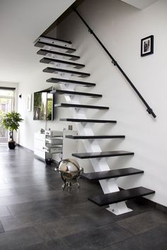 there is a black and white staircase in the house