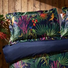 an image of a tropical themed bedding set with blue sheets and pillowcases