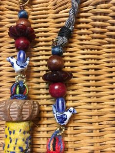 a close up of a necklace on a wicker basket