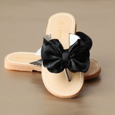 Dainty bow thong-style sandal for the absolutely pretty statement. Works great for summer fetes, Easter, and special occasions. Leather lined strap Patent upper: other material Oversized bow: satin Rubber sole Toddler sizes 7-13; Youth sizes 1-4. Trandy Shoes, Toddlers And Tiaras, Fashion Dress Up Games, Boys Fashion Trends, Kids Clothes Sale, Children Style, Cheap Kids Clothes