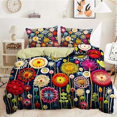 a bed with colorful flowers on it next to a white chair and clock in the background