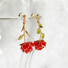 Handmade Red Rose Flower Earrings These beautiful handcrafted red rose flower earrings are the perfect way to add a unique and stylish flair to any outfit. The classic rose shape is made with great attention to detail and stands out beautifully. Enjoy the handmade and unique design of these earrings and make a bold fashion statement. As a gift shop, we offer a complimentary gift box for every order. Detail: - Size of earring: 20mm*40mm Material: flowers - resin; ear wires - sterling silver The Handmade Red Rose Flower Earrings are sold in pairs of two earrings. About postage: Standard postage When choosing standard postage, we assume this order is for yourself, or you will wrap the item yourself before giving it out as a gift (the complimentary gift box would be posted flat with your order Cheap Rose Red Earrings For Gift, Red Handmade Flower Earrings, Red Flower-shaped Earrings With Handmade Flowers, Handmade Flower-shaped Red Earrings, Rose Design Flower Earrings In Rose Gold, Rose Flower-shaped Earrings With Rose Design, Rose Red Flower Drop Earrings, Red Flower Charm Earrings, Rose-colored Drop Earrings With Rose Design