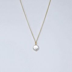 MVP's best selling necklace features a large iridescent coin pearl on a 14k gold filled rope. It's simple, striking, and makes a great gift. Materials 12-14 mm round white freshwater coin pearl with undertones of champagne, ivory and pink; 14k gold-filled chain, magnetic clasp.Size18" All jewelry is handmade by me in my Florida home studio. Orders ship free, and arrive gift wrapped and ready for giving. Please allow 1-3 business days for production. Coin Pearl Necklace, Coin Pearls, Gold Coin, Florida Home, Gold Coins, Magnetic Clasp, Gold Filled Chain, Modern Classic, Gold Filled