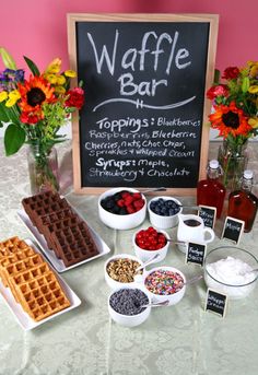 the waffle bar is ready to be served at your wedding or event with flowers in vases