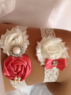 two garters with flowers and pearls on them