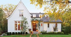 a white house with lots of windows in the front yard