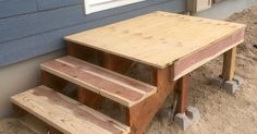 a wooden table and stairs in the sand