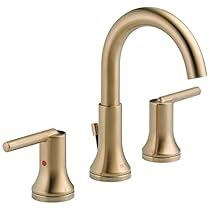 two handle bathroom faucet in brushed brass finish with matching handles and side spray