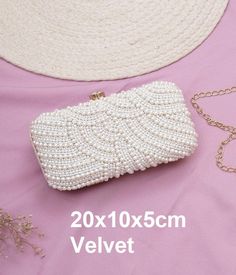 These elegant white clutch bags is the perfect accessory for any special occasion. Its intricate design and embellishments add a touch of luxury, while its functional size makes it comfortable and easy to use. Ideal for brides, bridesmaids, and guests, this statement piece is a must-have for any stylish wardrobe. Make a statement with this clutch. It has a compartment to keep your tiny essentials and is perfect for parties. This fancy number features a twist lock. Detachable shoulder chain strap with metal hooks, convertible design, can be used as a handbag, a shoulder bag, or a crossbody bag; good suture technique, refined bag bearing, a pretty clutch for girls and ladies.     Dimensions (L x B x H): Mentioned on photos     Occasion: Evening     Water Resistance: Not water resistant     C White Luxury Rectangular Evening Bag, Luxury White Rectangular Evening Bag, Formal White Bags With Pearl Handle, White Evening Bag With Pearl Handle As A Gift, White Pouch Bag For Party, White Rectangular Evening Bags, White Clutch Bag For Formal Occasions, Evening Clutch In Pearl White With Pearl Embroidery, Pearl White Evening Clutch With Pearl Embroidery