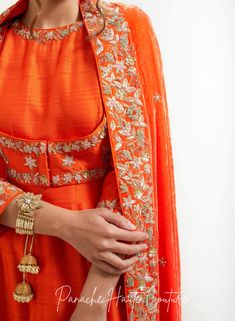 An orange silk velvet shawl with zardozi embroidery is a stunning and vibrant accessory that is perfect for adding a touch of luxury and elegance to any outfit. Silk velvet is a plush and soft fabric that has a subtle sheen, while zardozi embroidery is an intricate and traditional style of Indian embroidery that involves metallic threads and beads. Styling Tips: When styling an orange silk velvet shawl with zardozi embroidery, it's important to let the shawl be the focal point of the outfit. Pair it with neutral colors such as black or white to make the vibrant orange color stand out. Alternatively, you can pair it with complementary colors such as gold, yellow, or red for a bold and striking look. The zardozi embroidery on the shawl adds texture and visual interest, making it an ideal acc Velvet Shawls, Zardozi Embroidery, Curated Outfit, Velvet Shawl, Saree Gown, Embroidery Materials, Computerized Embroidery, Types Of Embroidery, Indian Embroidery