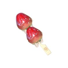 two red candy lollipops sitting on top of each other