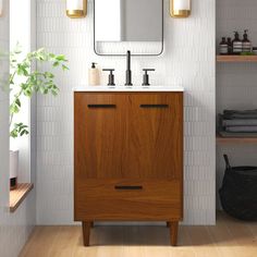 a bathroom with a wooden cabinet and two mirrors on the wall, along with shelving