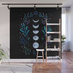 a wall mural with the phases of the moon and stars in blue on a black background