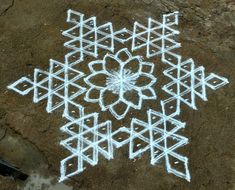 an image of snowflakes drawn on the ground with chalk and white marker paint