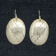 "Vintage Navajo dangle earrings. They were formerly post earrings and converted to pierced dangles with ear wires. The earrings are large oval disks that were hand crafted and stamped by Navajo artisan D Vandever. Their full length is 1 7/8\" and the dangle portion 1 1/4\" x 7/8\". They weigh 6.2 grams and are stamped sterling D Vandever. The earrings are in good vintage condition with a nice luster and shine to them. They have some signs of age and wear. Items come in a brightly colored paper b Vintage Navajo, Colored Paper, Silver Earrings Dangle, Ear Wires, Post Earrings, Hand Stamped, Dangle Drop Earrings, Full Length, Hand Crafted