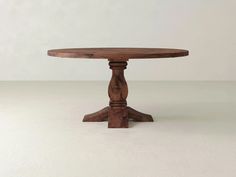 a wooden table sitting on top of a white floor