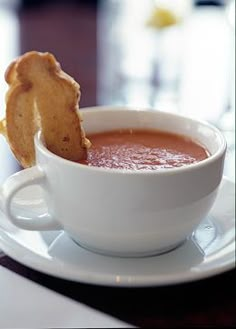 a bowl of soup and some bread on a plate