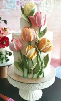 a three tiered cake with flowers on it